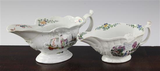 Two early Worcester polychrome sauceboats, c.1753-5, 7in. & 7.5in., repairs